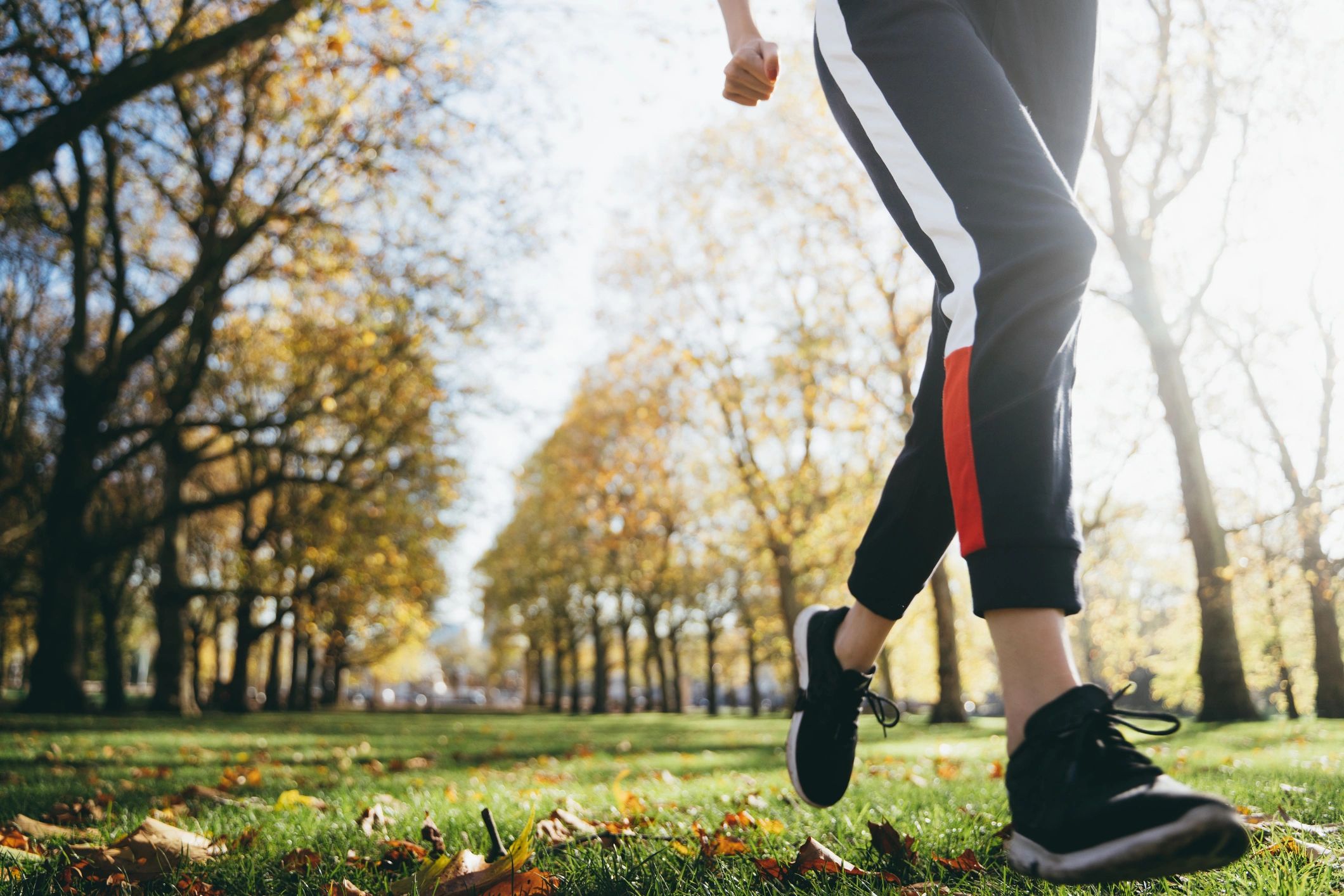 Close-up of a woman running outdoors in activewear
