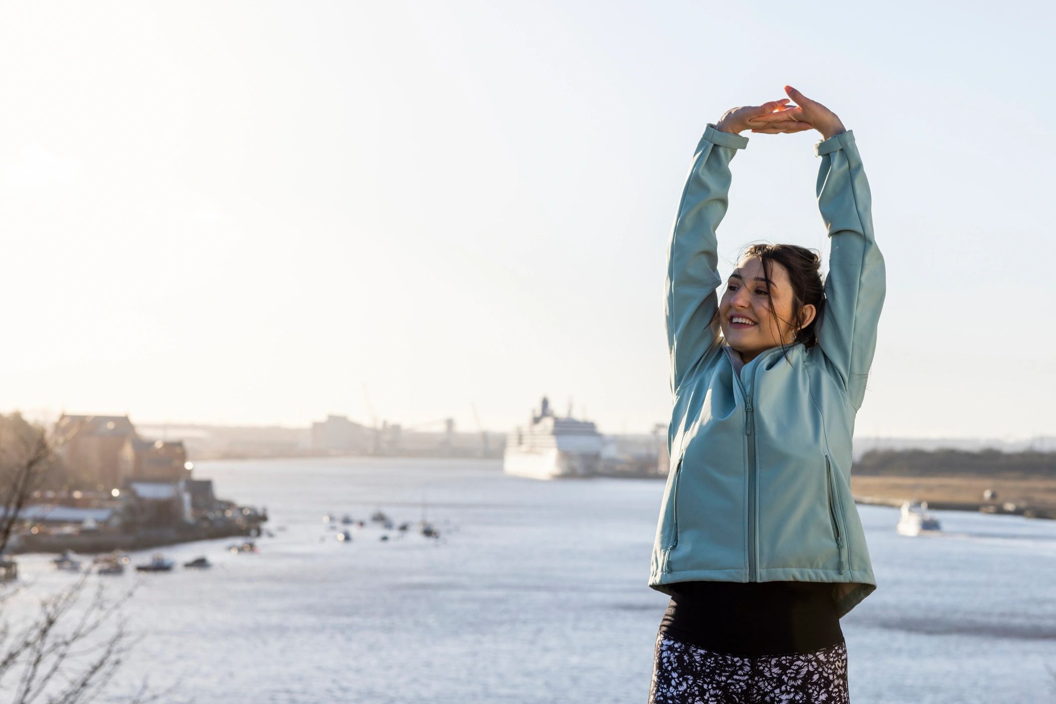 Woman stretching outdoors in stylish activewear